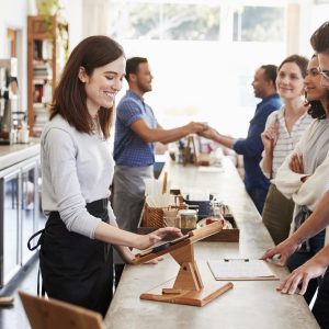 Customers queuing to order and pay at a coffee shop counter